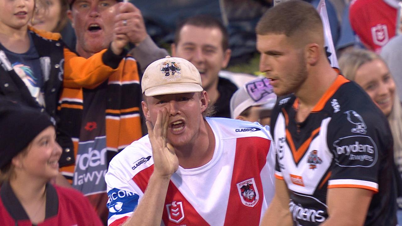 Tigers kicker Adam Doueihi is sprayed by a Dragons fan during a conversion.