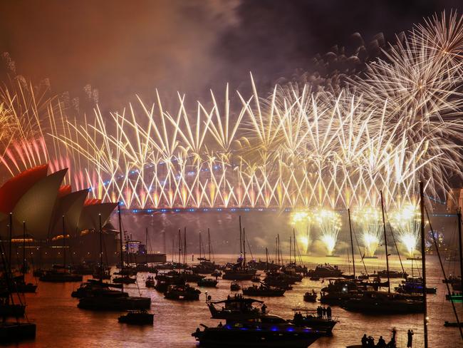 SYDNEY, AUSTRALIA - JANUARY 01: Fireworks light up the sky over the Sydney Harbour Bridge and the Sydney Opera House during New Year's Eve celebrations on January 01, 2024 in Sydney, Australia. Revellers turned out in large numbers to celebrate the new year in Australia. (Photo by Roni Bintang/Getty Images) *** BESTPIX ***