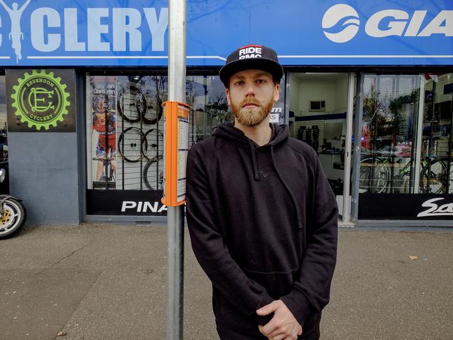 Riley Uebergang at the temporary bus stop outside his Essendon store. Picture: Luis Enrique Ascui