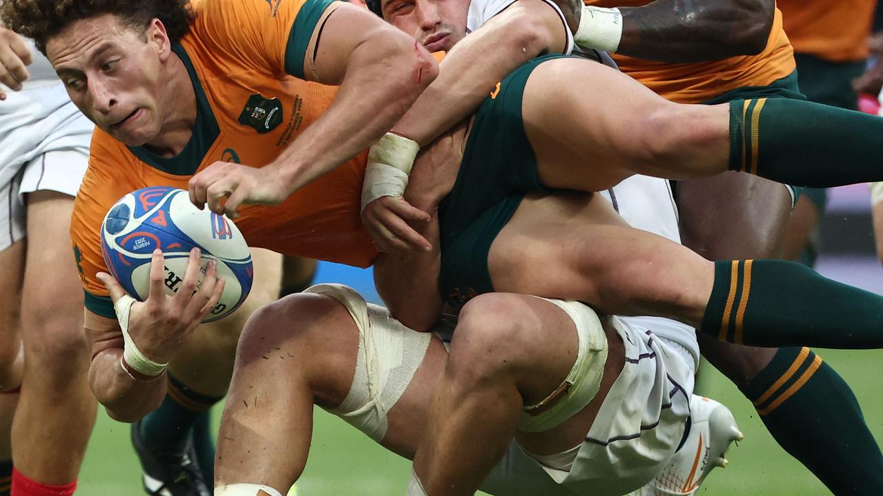 Australia's right wing Mark Nawaqanitawase (C) is tackled by Georgia's blindside flanker Tornike Jalagonia (C) during the France 2023 Rugby World Cup Pool C match between Australia and Georgia at Stade de France in Saint-Denis, on the outskirts of Paris, on September 9, 2023. (Photo by FRANCK FIFE / AFP)