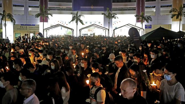 Protesters light candles to pay homage to Chow Tsz-Lok. Picture: AP