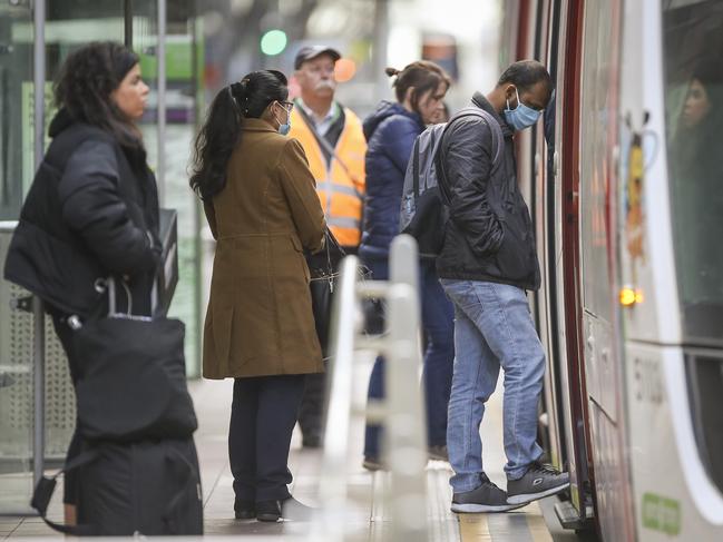 Commuters in masks around Southern Cross Station. Picture: Wayne Taylor