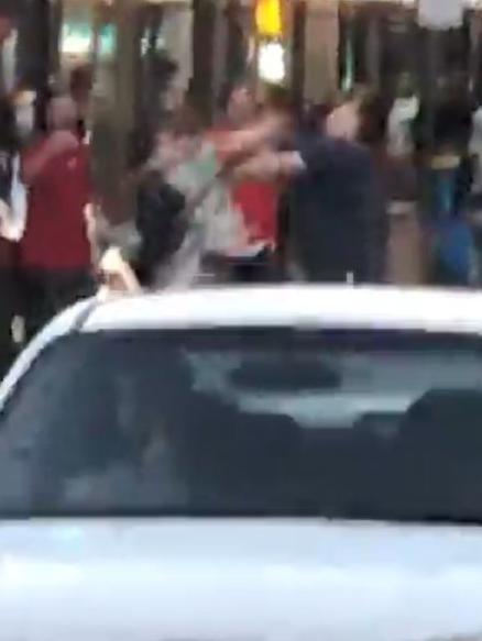 Punches are thrown in front of bemused bystanders and drivers. Picture: Supplied