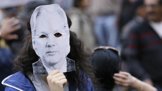 A protester wearing a Julian Assange mask in Ecuador last week. Picture: AP 