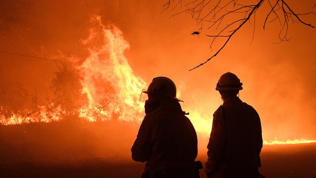 NSW Rural Fire Service crews protect properties on Kellyknack Rd as the Wrights Creek fire approaches Mangrove Mountain north of Sydney, on December 5. Picture: Dan Himbrechts