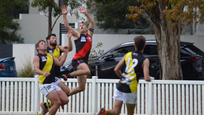 Michael ‘Buddy’ Spohn launches for a mark for the Jets. Pic: Black Rock FNC