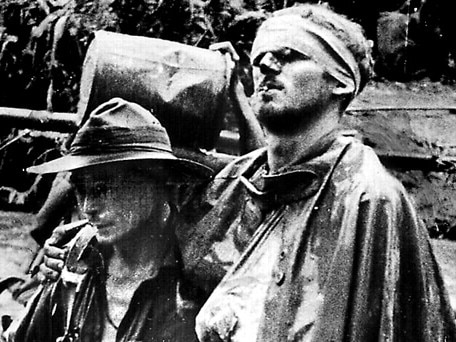 Millennium collection - 1000 years of war - Wounded Aust soldier William 'Wally' Johnson (r) being lead by medic G R C Ayer (l) on the Kokoda Trail, Papua New Guinea during World War II. two historical /World/War/1939/45