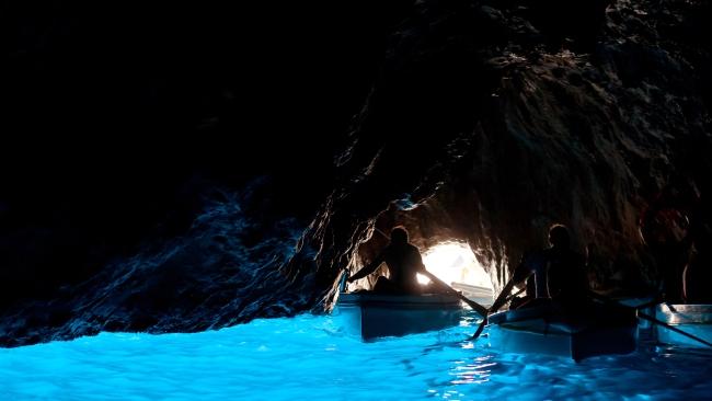 4/5
Grotto Azzurra 
Translated to Blue Grotto, this magical sea cave on the coast of Capri was the personal swimming hole for Emperor Tiberius.
Sunlight passes through an underwater breach and illuminates the cavern in blue. It can only be reached by squeezing through a narrow entrance, when the tide is right and the sea isn’t too choppy.
Only four passengers can enter the cave at any time and you need to lay on your back as the rowboat pulls in. When I was last in Capri, I decided to wait a day to book a tour and for the rest of my time there, the sea was too rough to tour the Grotto.