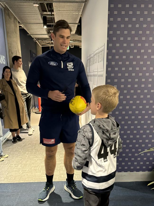 Harry getting a signature from Tom Hawkins. Picture: Supplied