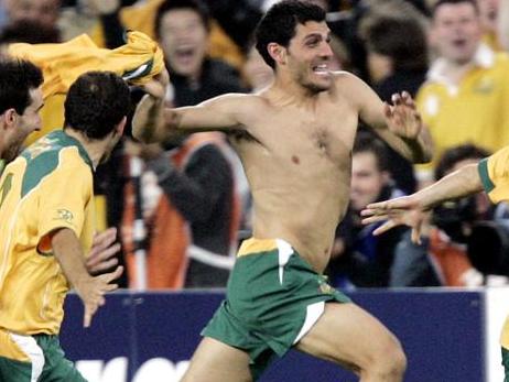 WIRE: Socceroos (L-R) Tony Vidmar, Scott Chipperfield, John Aloisi and Vincent Grella celebrate after defeating Uruguay on penalties during their second leg World Cup qualifier, Australia v Uruguay at Sydney's Telstra Stadium, 16/11/2005. Australia booked a World Cup 2006 finals berth for the first time in 31 years.