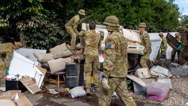 The army cleans up household waste around the streets of Milton on Monday. Picture: NCA NewsWire / Sarah Marshall
