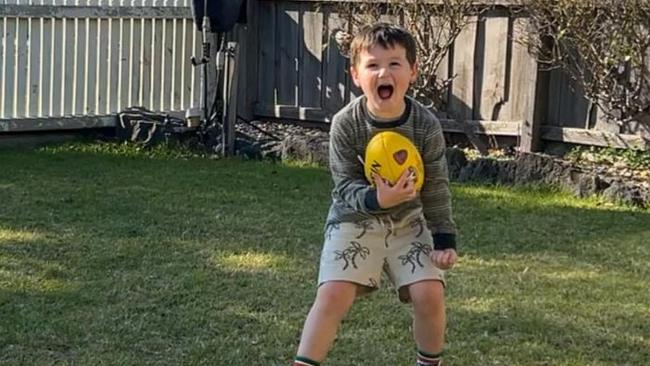 Harry with his beloved footy. Picture: Supplied