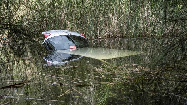 Emergency services responded to reports of a car leaving the roadway on Pittwater Road at Dee Why, before crashing through bushes and coming to rest into Dee Why Lagoon. Picture: NCA NewsWire / Monique Harmer