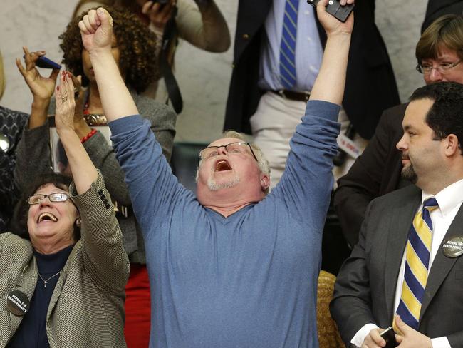 Kirk Bloodsworth, the first American sentenced to death row who was exonerated by DNA, and National Association for the Advancement of Colored People president Ben Jealous, right, react after watching the Maryland General Assembly approve a measure to ban capital punishment.