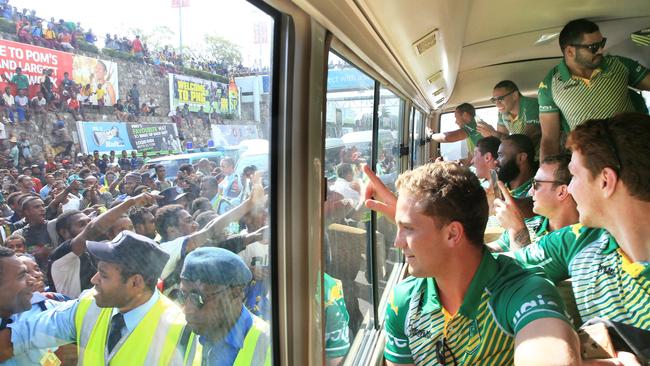 The PM's XIII are mobbed as they arrive in Port Moresby. Pic: Mark Evans.