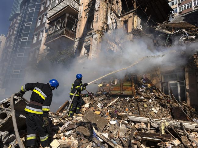 Firefighters appear on the scene to put out a fire in a four story residential building after a "kamikaze drone" attack early Monday morning. Picture: Paula Bronstein /Getty Images)