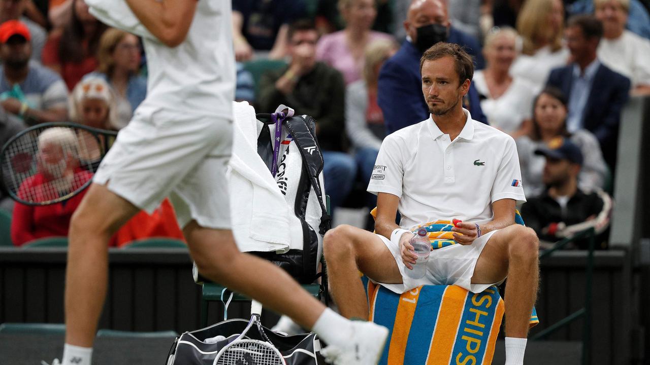 (FILES) In this file photo taken on July 06, 2021 Russia's Daniil Medvedev (R) reacts during a break in play against Poland's Hubert Hurkacz in their men's singles fourth round match on the eighth day of the 2021 Wimbledon Championships at The All England Tennis Club in Wimbledon, southwest London. - Wimbledon has banned Russian and Belarusian players from the 2022 tournament in response to the invasion of Ukraine, but ATP and WTA organisers branded the move "unfair" and "very disappointing" on April 24, 2022. The players targeted include Russian men's world number two Daniil Medvedev and Belarusian female world number four Aryna Sabalenka. And also Russia's Andrey Rublev, who is currently eighth in the ATP rankings, while his compatriot Karen Khachanov is in 26th place. Russian world number 15 Anastasia Pavlyuchenkova and Victoria Azarenka of Belarus are two of the other top female players who will miss the grass-court Grand Slam. (Photo by Adrian DENNIS / AFP) / RESTRICTED TO EDITORIAL USE