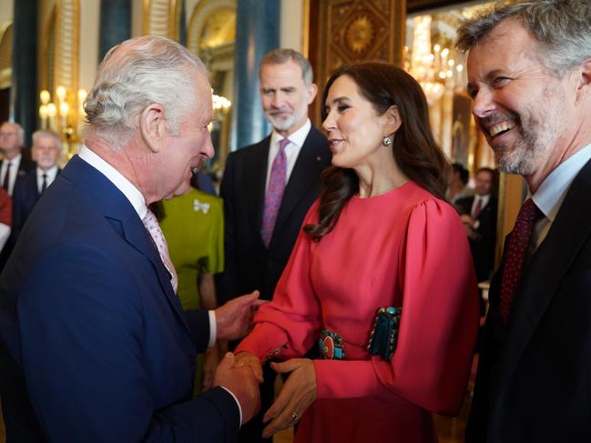 LONDON, ENGLAND - MAY 05: King Charles III (L) greets Mary, Crown Princess of Denmark and Crown Prince Frederik of Denmark, during a reception at Buckingham Palace for overseas guests attending his coronation on May 5, 2023 in London, England. (Photo by Jacob King - WPA Pool / Getty Images)