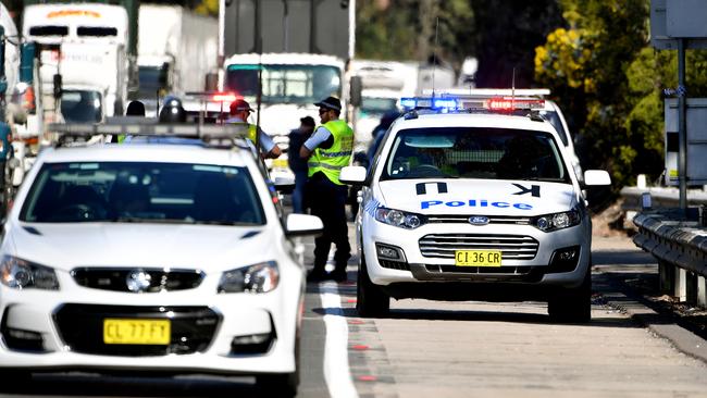 Police establish a crime scene on the M1 near Mount Kuring-Gai in Sydney. Picture: AAP Image/Joel Carrett