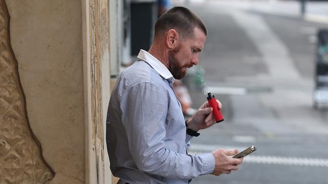 Jason Akermanis relaxing with a vape outside Ipswich Courthouse on May 31 during his court appeal. Picture: Adam Head
