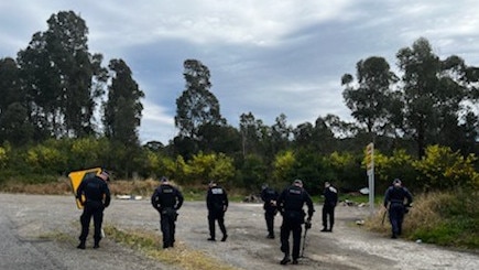 Police search an area near the intersection of Wakefield and Sugarloaf Range roads on August 11, 2022 as part of an investigation into the kneecapping of a Nomads bikie nominee.