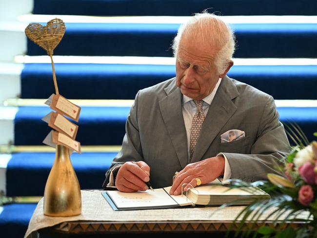 King Charles signs a book of condolence. Picture: Getty Images