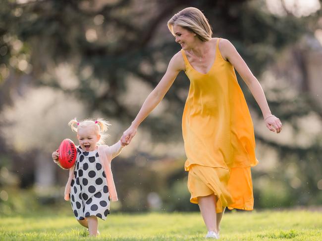 Sarah Jones, with her daughter Mila, is pleased the landscape in sports reporting is changing for future generations. Picture: Jason Edwards