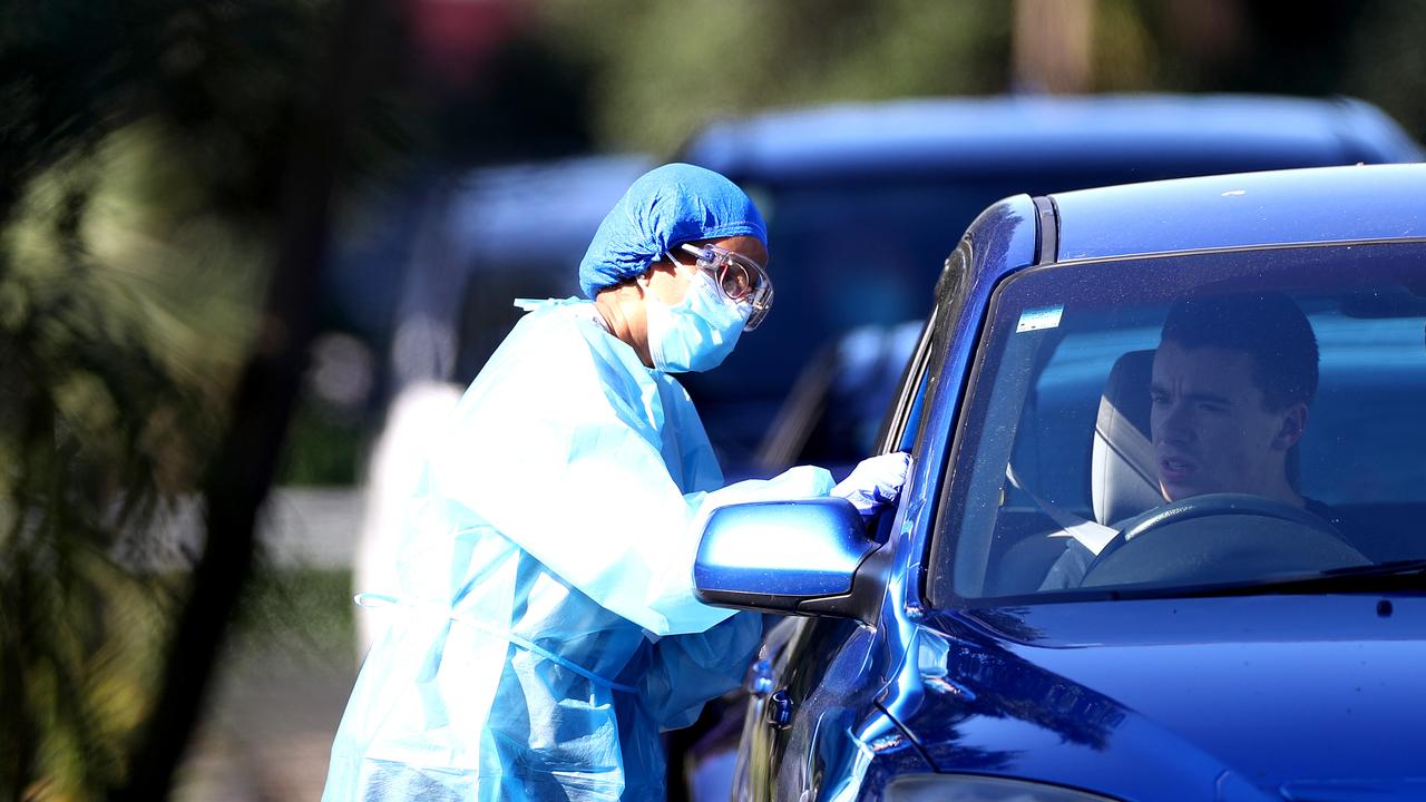 A nurse tests members of the public at the Eden Park testing station in Auckland, New Zealand on Sunday. Picture: Hannah Peters / Getty Images