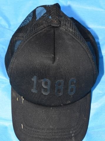 The black cap with ‘1986’ printed on the front.