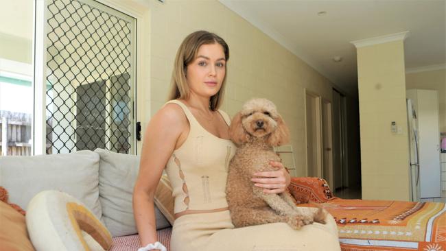 The 27-year-old disability support worker is pictured here, after cleaning up her ransacked property, with her dog Sassy. Picture: Peter Carruthers