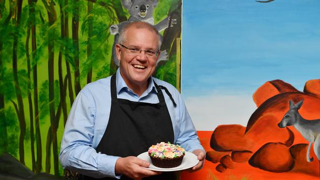 Scott Morrison tries his hand at cake decorating while on the campaign trail in Brisbane yesterday. Picture: Mick Tsikas/AAP