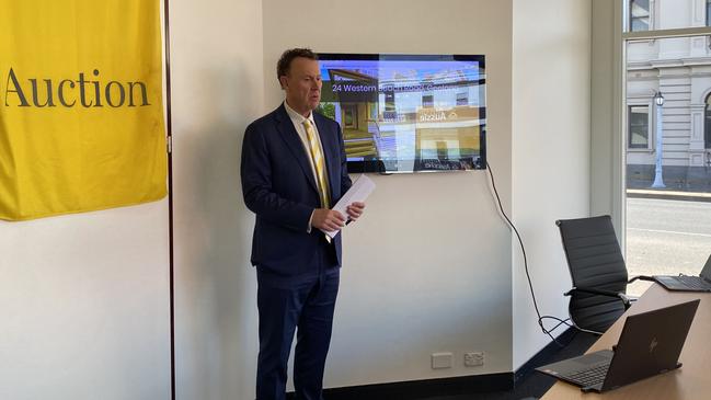 Ray White, Geelong agent Laurie McGovan conducts the online auction of 24 Western Beach Rd, Geelong on Saturday.