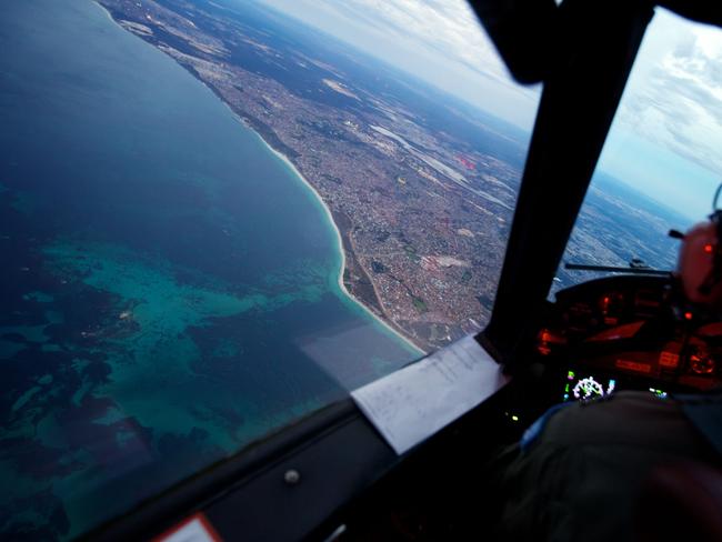 Crew on-board an RAAF AP-3C Orion crosses the coast of Perth, having just completed an 11 hour search mission for missing Malaysia Airways Flight MH370 on March 24, 2014. Picture: Getty