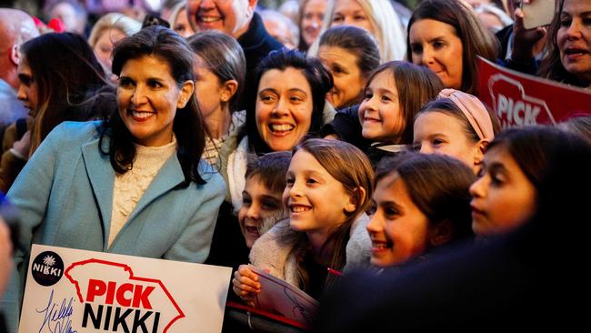 Nikki Haley takes pictures with young attendees at the conclusion of a campaign rally in Charleston, South Carolina. Picture: Getty Images via AFP.