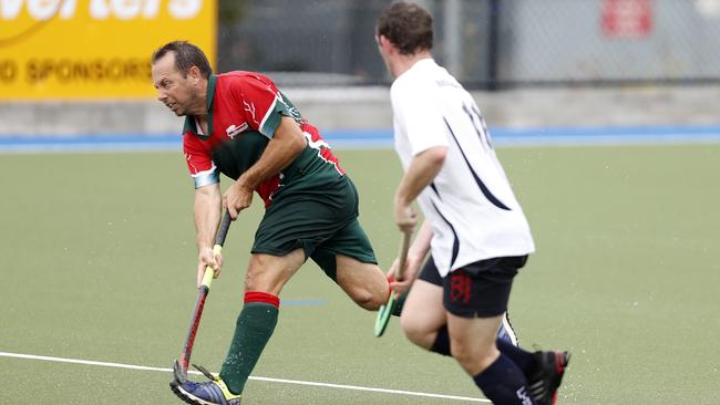 Jeff Lancaster of Redcliffe Red Schwarz team against Mitchel Smith of the Queensland Police and Emergency services side during the Brett Forte memorial hockey match played at the Mary Nairn Fields, Redcliffe, Saturday, October 6, 2018. Picture: AAP /Regi Varghese