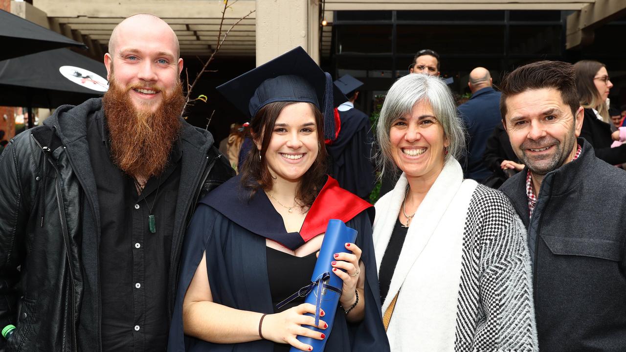 Deakin graduate Isabella Clark with finance Bailey Bergmans, left, and parents Angela and Michael. Picture: Alison Wynd