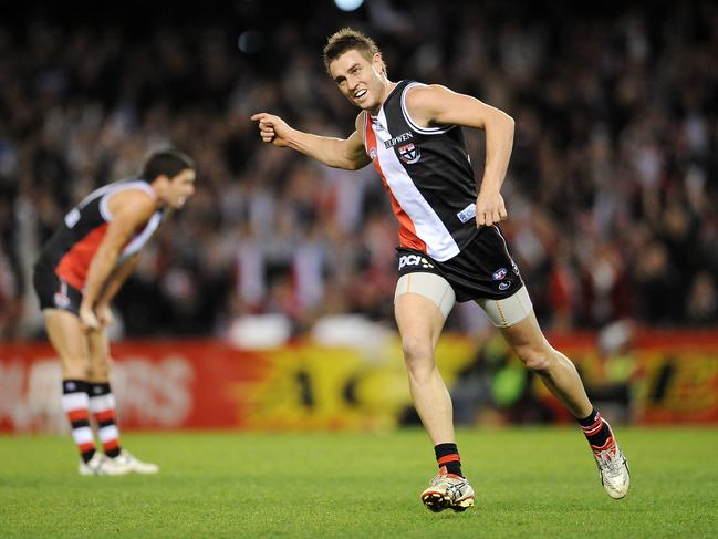 Fisher celebrates a goal against Geelong.