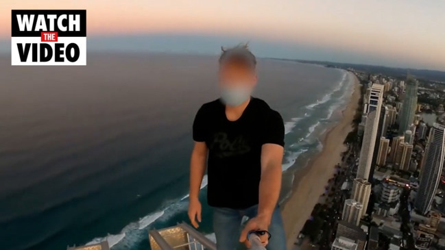 Man dangles from crane at Surfers Paradise