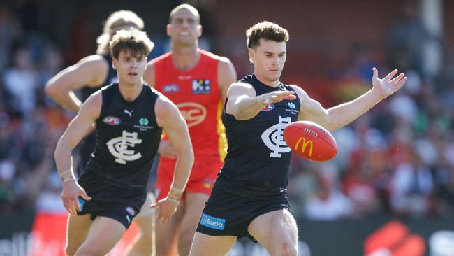 Blake Acres kicks Carlton forward. Picture: Russell Freeman/AFL Photos via Getty Images.