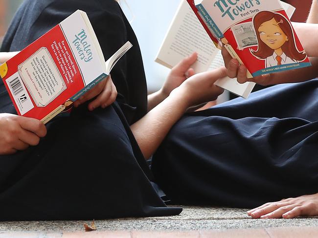 St Margaret's Anglican Girls School students Ella Sedgwick 16, Emily Tonkin 11, Penny Crothers 17, Bella Griffiths 13 with Enid Blyton books. Pic Peter Wallis