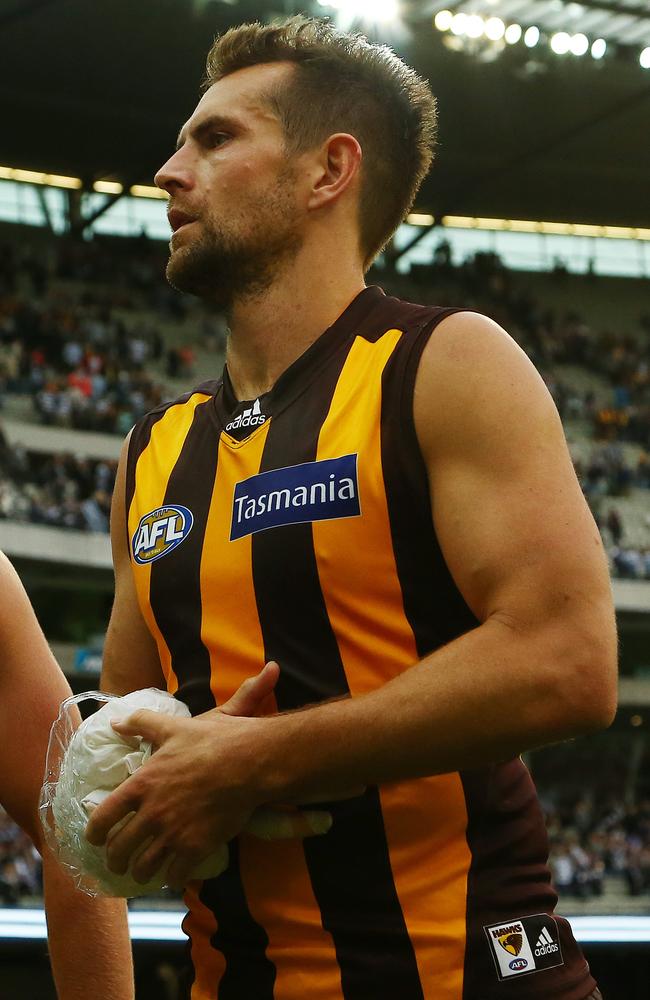 Luke Hodge cradles his injured arm after his side’s loss to Geelong. Picture: George Salpigtidis