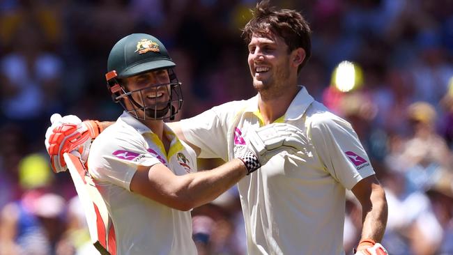 Australia's Mitchell Marsh (R) and brother Shaun (L) celebrate during last year’s Ashes — but have since come under pressure for their spots. Picture: AFP