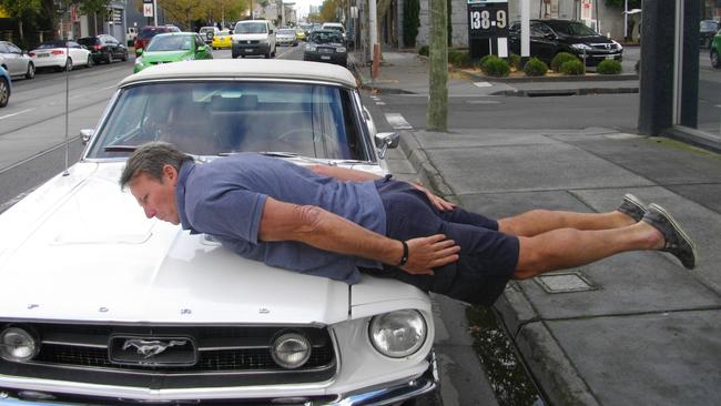 Sam Newman planking on a car.