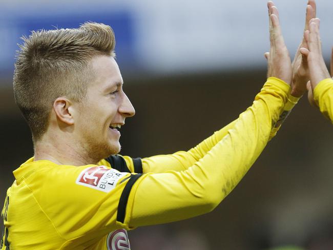 Dortmund's Marco Reus celebrates his side's second goal during the German first division Bundesliga soccer match between SC Paderborn 07 and Borussia Dortmund in Paderborn, Germany, Saturday, Nov. 22, 2014. (AP Photo/Michael Probst)