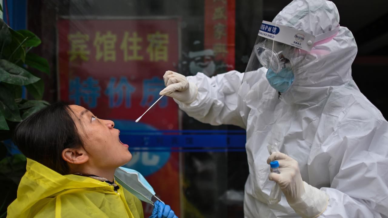 A medical worker takes a swab sample from a person to be tested for Covid-19 in 2020. (Photo by Hector RETAMAL / AFP)