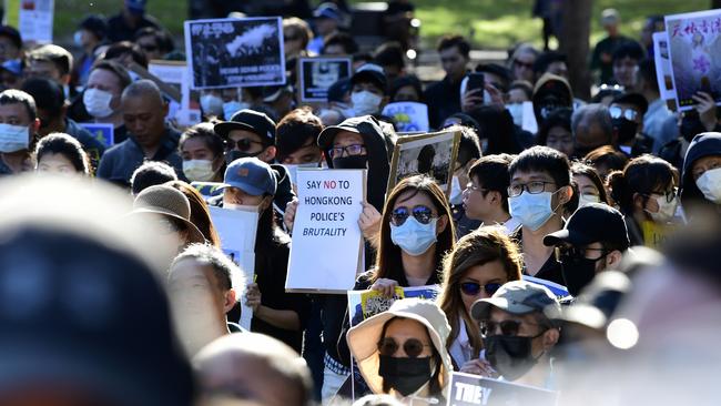 Pro-democracy Hong Kong supporters hold placards during a demonstration in Sydney on Sunday.