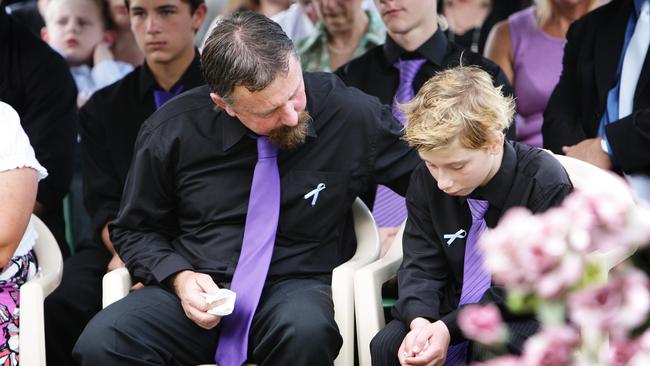 John Tyson comforts his son Blake Rice - Funeral of Donna Rice, 43 and her son Jordan, 13 at Drayton and Toowoomba Cemetery, Toomoomba. Donna and Jordan are victims of the flash floods that swept through Toowoomba and on to Brisbane.