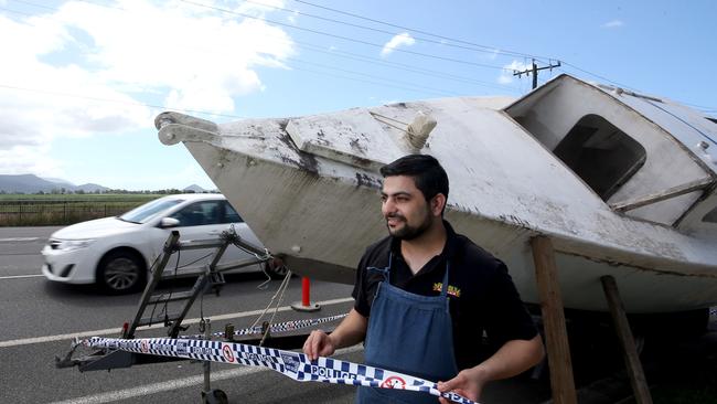 Owner of Punjabi Nights at Freshwater Deepak Kumar in front of the yacht that has been dumped on the side of Kamerunga Rd. PICTURE: ANNA ROGERS