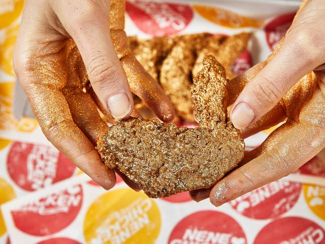 Caitlyn McMahon with the 23 karat gold chicken from Nene Chicken in Casuarina. Top Enders will have a chance to win some of them on National Fried Chicken day (July 6). PICTURE: GRIFFIN SIMM