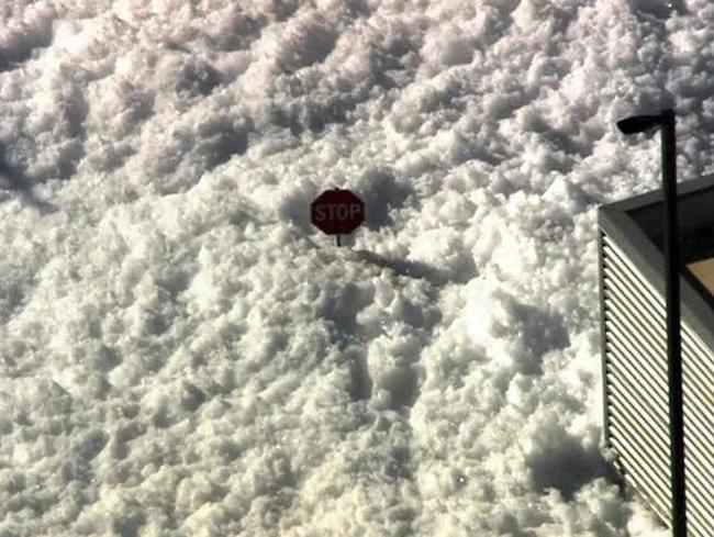 The sea of foam rose almost to the top of this stop sign.